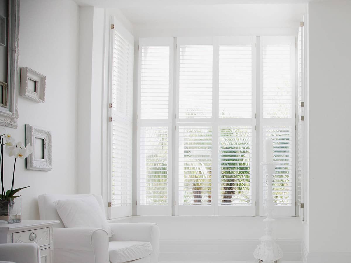 white interior shutters in a sitting room
