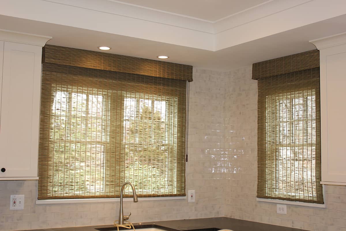 natural woven shades over kitchen windows