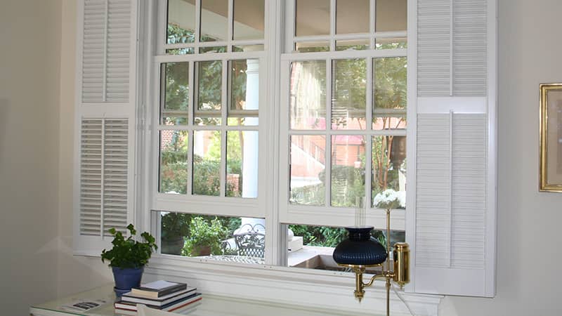 traditional shutters above a desk