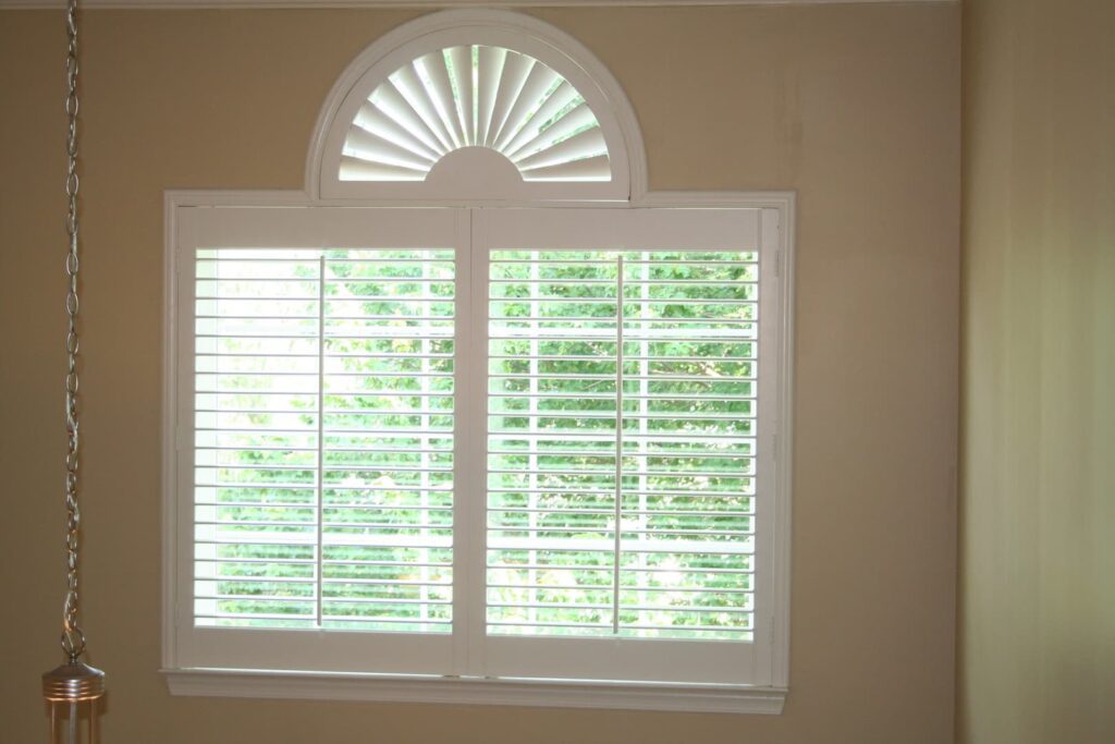 3 1/2" louvered interior shutters with sunburst shutter on half-circle window